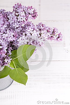 Bouquet of lilac flowers on white wooden background Stock Photo