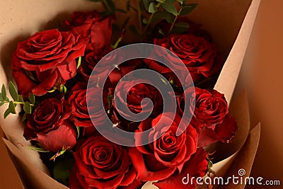 Bouquet of lush beautiful fresh red roses in kraft paper. Happy valentine`s day. Stock Photo