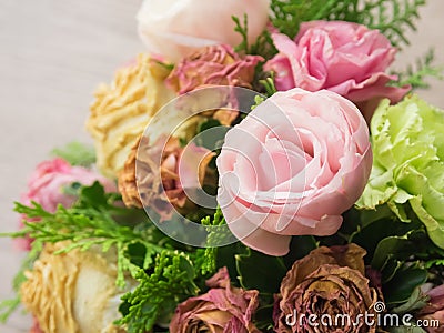 Bouquet of mixed flowers on wood background, Roses, Carnation, Eustoma, dry flowers Stock Photo