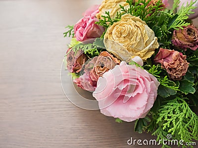 Bouquet of mixed flowers on wood background, Roses, Carnation, Eustoma, dry flowers Stock Photo