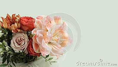 A bouquet of peach daylilies, orange and pink roses and beige chrysanthemums on light green background. Closeup. Stock Photo