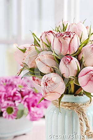 Bouquet of pink roses in turquoise ceramic vase Stock Photo
