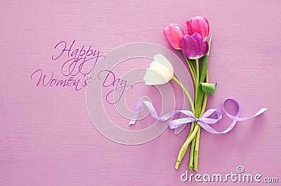 bouquet of pink and white tulips over pastel wooden background. Top view. International women day concept. Stock Photo