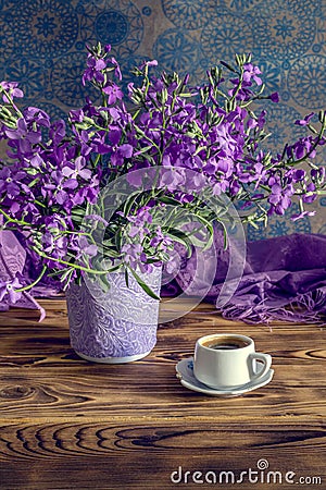 The bouquet of plant Matthiola farinosa and cup of coffee close-up Stock Photo