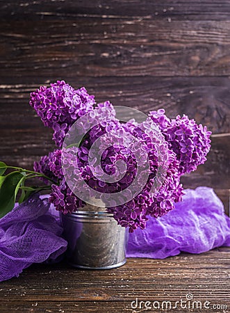 Lilac flowers in decorative tin bucket Stock Photo