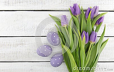 Bouquet of purpleviolet tulips and painted easter eggs on whit Stock Photo