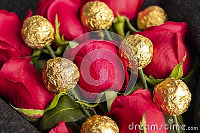 Bouquet of red roses with golden chocolate Stock Photo