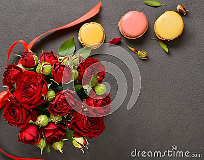 bouquet of red roses and macaroon cookies Stock Photo