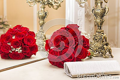 Bouquet of red roses reflected in the mirror, white clutch, flowers Stock Photo