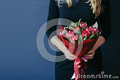 Bouquet of red tulips in girs hands. Unrecognisable. Stock Photo