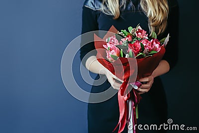 Bouquet of red tulips in girs hands. Unrecognisable. Stock Photo