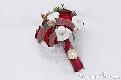 Bouquet of roses and cones in the snow. Stock Photo