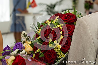 Bouquet of roses in man hands. Weddind details in closeup view. Solemn event Stock Photo