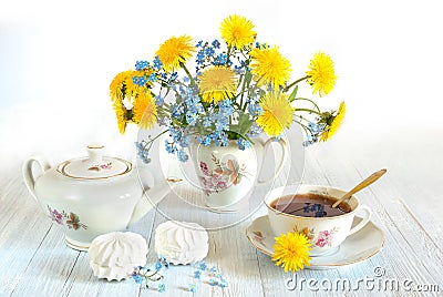 Bouquet of spring flowers. Spring still life of dandelions, forget-me-nots and cups of tea. Isolated on white background Stock Photo