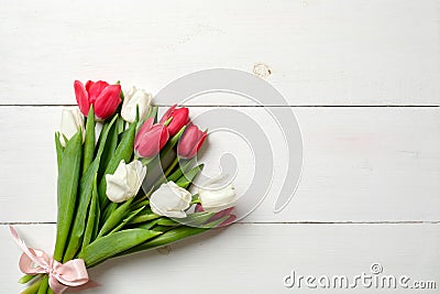 Bouquet of tulips on white wooden table, copy space for text. Invitation or congratulation banner mockup for spring holidays, Inte Stock Photo