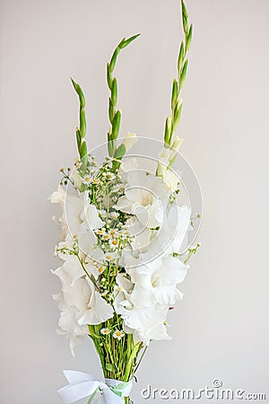 Bouquet of white gladioli. Whiteness delicate gladiolus flowers. Close up on white background Stock Photo