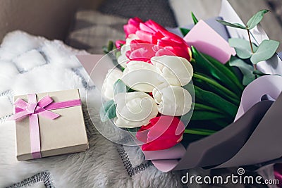 Bouquet of white and pink tulips with gift box at home. Spring flowers. Women`s day. Present for Mother`s day Stock Photo