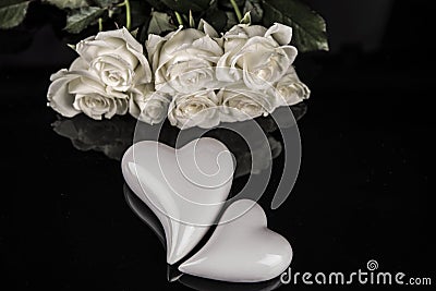 A bouquet of white roses, angels of love and porcelain hearts, Valentine`s Day Stock Photo
