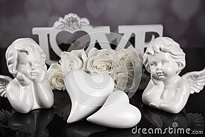 A bouquet of white roses, angels of love and porcelain hearts, Valentine`s Day Stock Photo