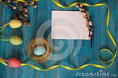 Bouquet willow branch and Easter eggs on a wooden table Stock Photo