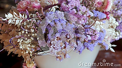 Bouquets with white, purple and violet dried flowers and leaves for sale in flower shop. Stock Photo