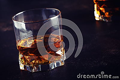 Bourbon in glass, american corn whiskey, dark bar counter, selective focus Stock Photo