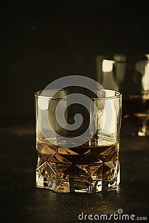 Bourbon in glass, american corn whiskey, dark bar counter, selective focus Stock Photo