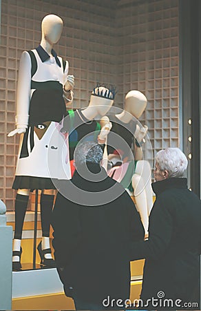 Boutique fashion display window with dressed mannequin in modern Editorial Stock Photo