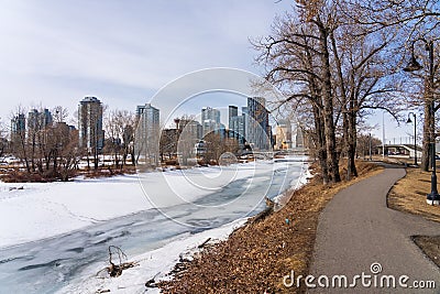 Bow River Pathway during winter. Frozen Bow River, St. Patricks Island Park. Downtown Calgary. Editorial Stock Photo