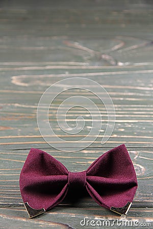 Bow tie coloring Marsala on a wooden background Stock Photo