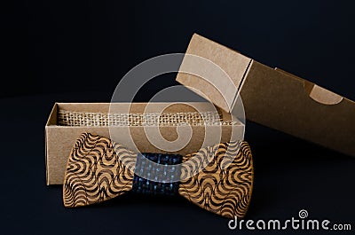 Bow tie made of handmade wood, on a black background.jpg Stock Photo