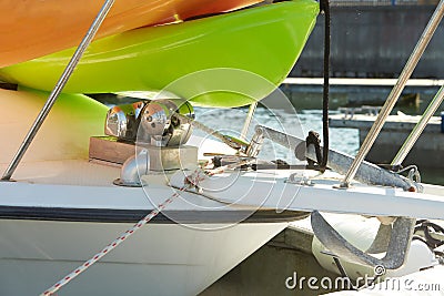 The bow of the yacht with anchor stops, a winch, a bollard with a mooring rope fixed to it and part of the anchor chain. Stock Photo