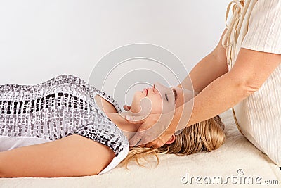 Bowen treatment of a young woman`s head. Stock Photo