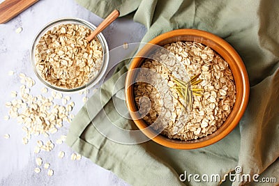 a bowl of banana oatmeal next to a bag of oats Stock Photo