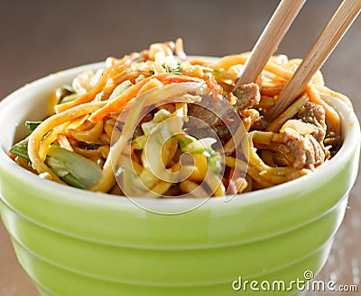 bowl of beef lo mien in a bowl with chopsticks Stock Photo