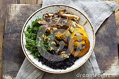 Black rice with roasted delicata squash, massaged kale and shiitake mushrooms Stock Photo