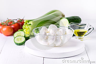 Bowl of Bocconcini Mozzarella Fresh Tomatoes Cucumber Celery Olive Oil Italian Salad Healthy Food White Background Stock Photo
