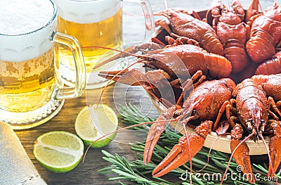 Bowl of boiled crayfish with two mugs of beer Stock Photo