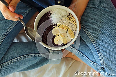 Bowl breakfast in the bed. Breakfast girl a bowl. Stock Photo