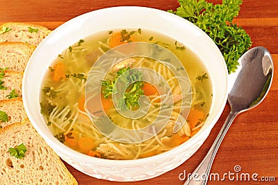 Bowl with chicken soup with vegetables and chicken meat, toasted bread Stock Photo