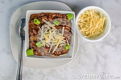 chili top with shredded cheese and scallions Stock Photo