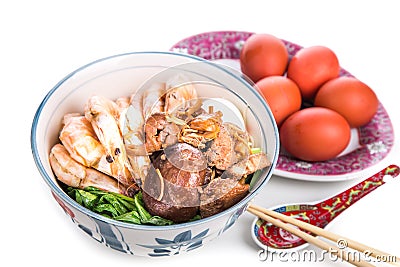 Bowl of Chinese birthday noodle with seafood, meat, red eggs Stock Photo