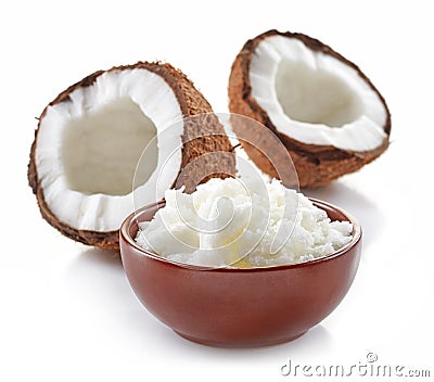 Bowl of coconut oil and fresh coconuts Stock Photo