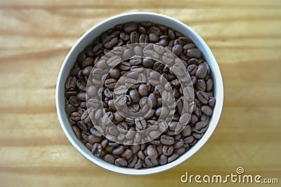 Bowl of coffee beans on the wood table Stock Photo