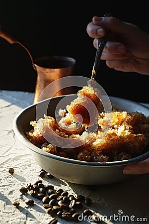 Bowl with a cold coffee dessert and coffee beans on the table is a side view. Sicilian granite Stock Photo