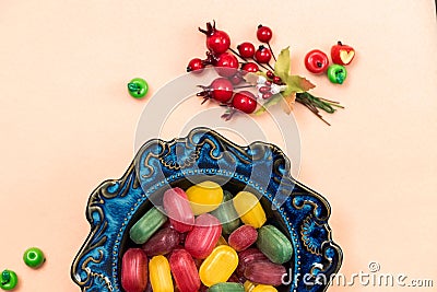 Bowl with colorful caramels, lollipops for resorption with fruit flavors Stock Photo