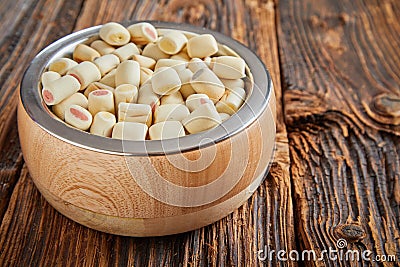 Bowl of commercial doggy biscuits sausage rolls Stock Photo