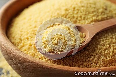 Bowl with couscous and spoon on wooden background Stock Photo