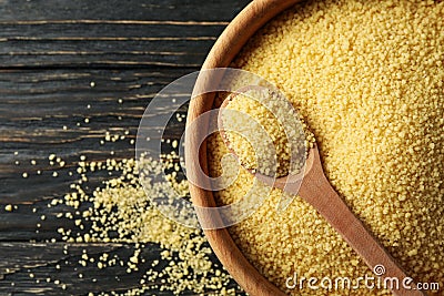 Bowl with couscous and spoon on wooden background Stock Photo