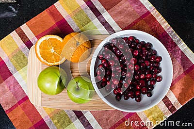 Bowl of cranberries with apples and oranges Stock Photo